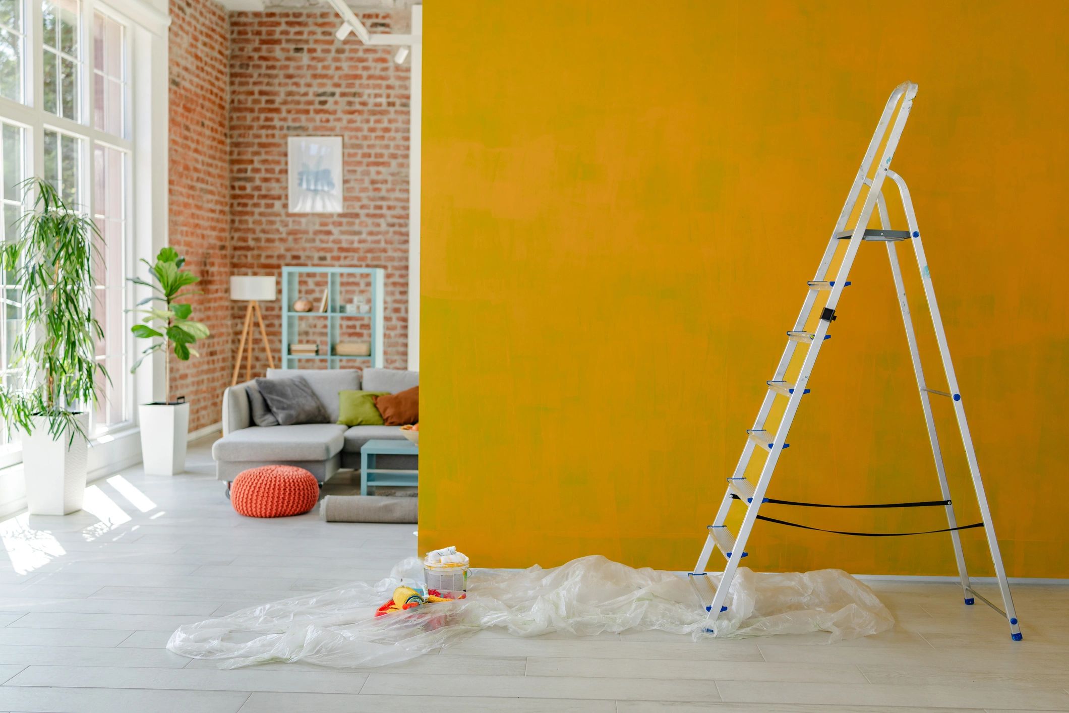 Home improvement scene with ladder and painted wall during renovation