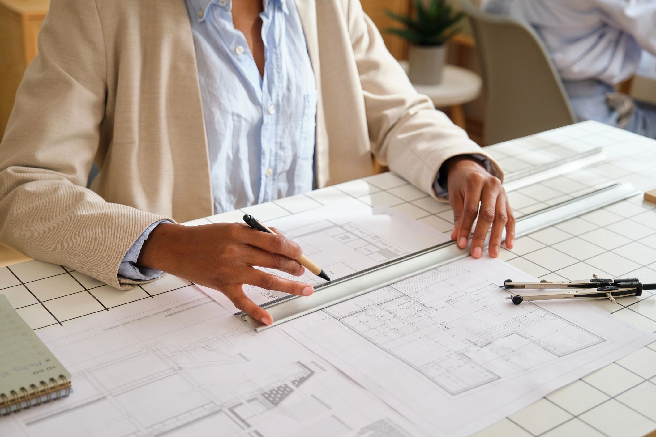 Architect working on space planning drawings at a desk